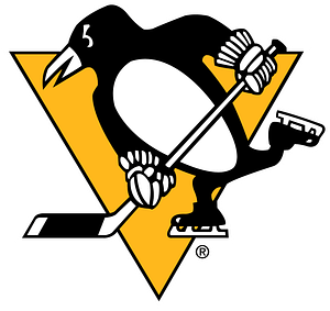 Penguin wearing skates and holding a hockey stick stands in front of a yellow triangle.