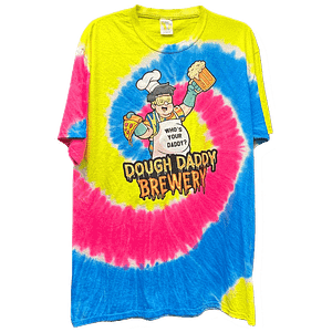 A tie-dye T-shirt with pink, yellow, and blue swirls featuring a cartoon chef holding a pizza and beer, text reads "Dough Daddy Brewery".