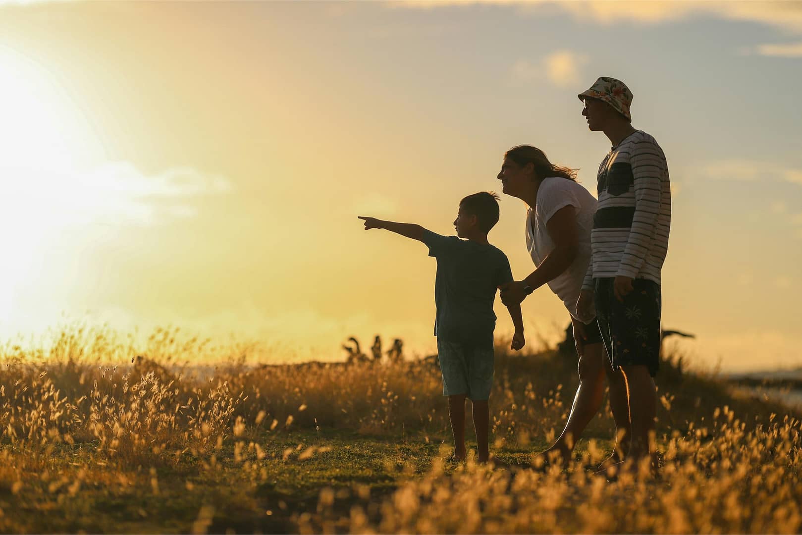 Family in a field during sunset