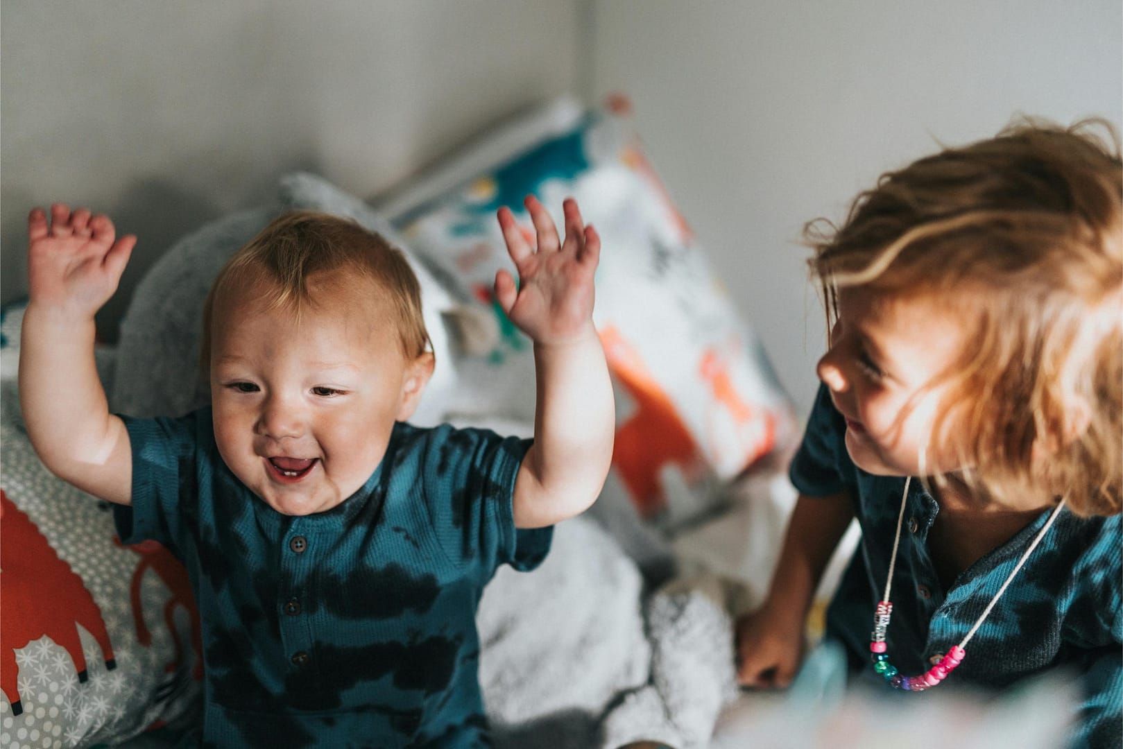 Happy toddler with arms in the air