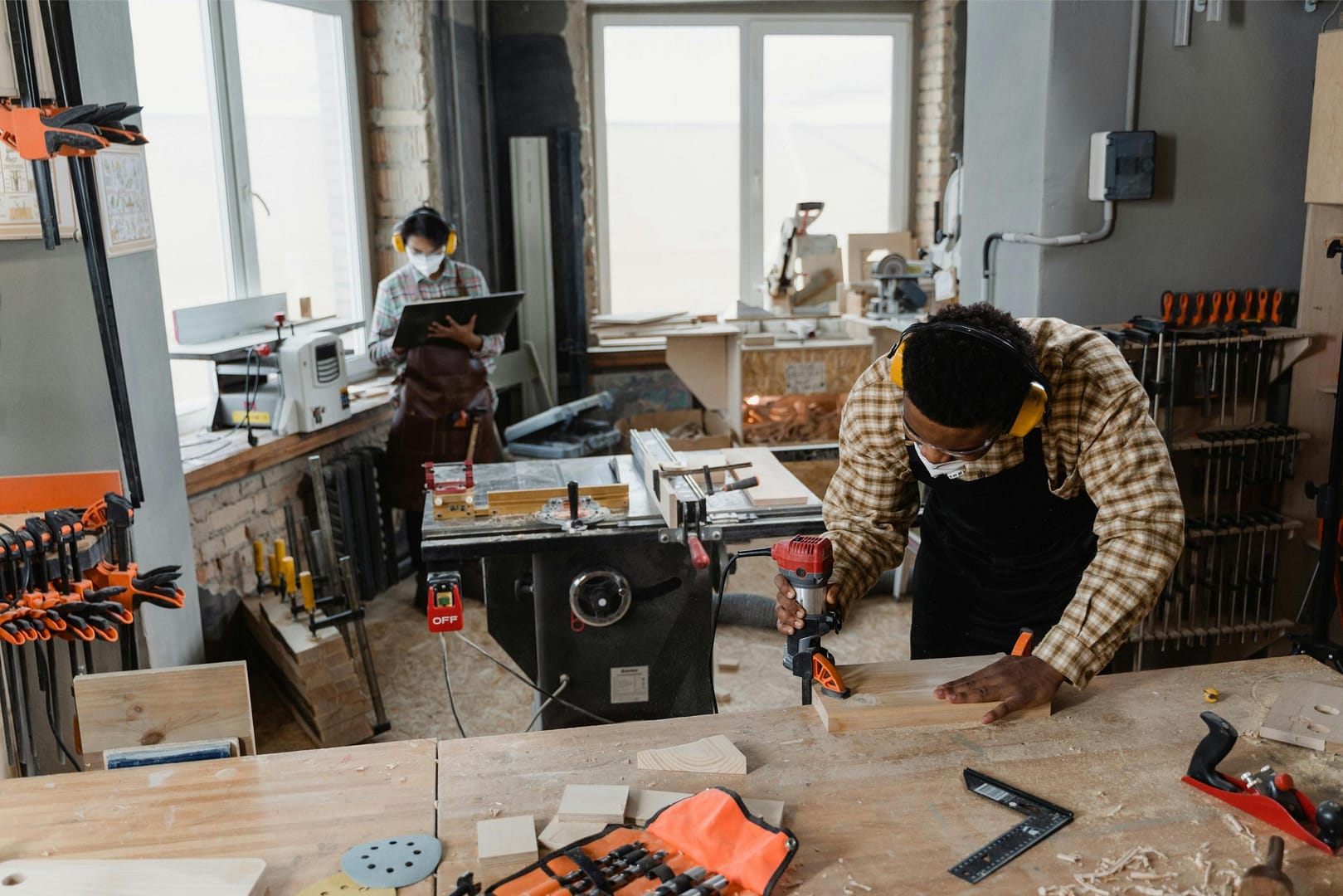 Carpenter and small business owner working in workshop
