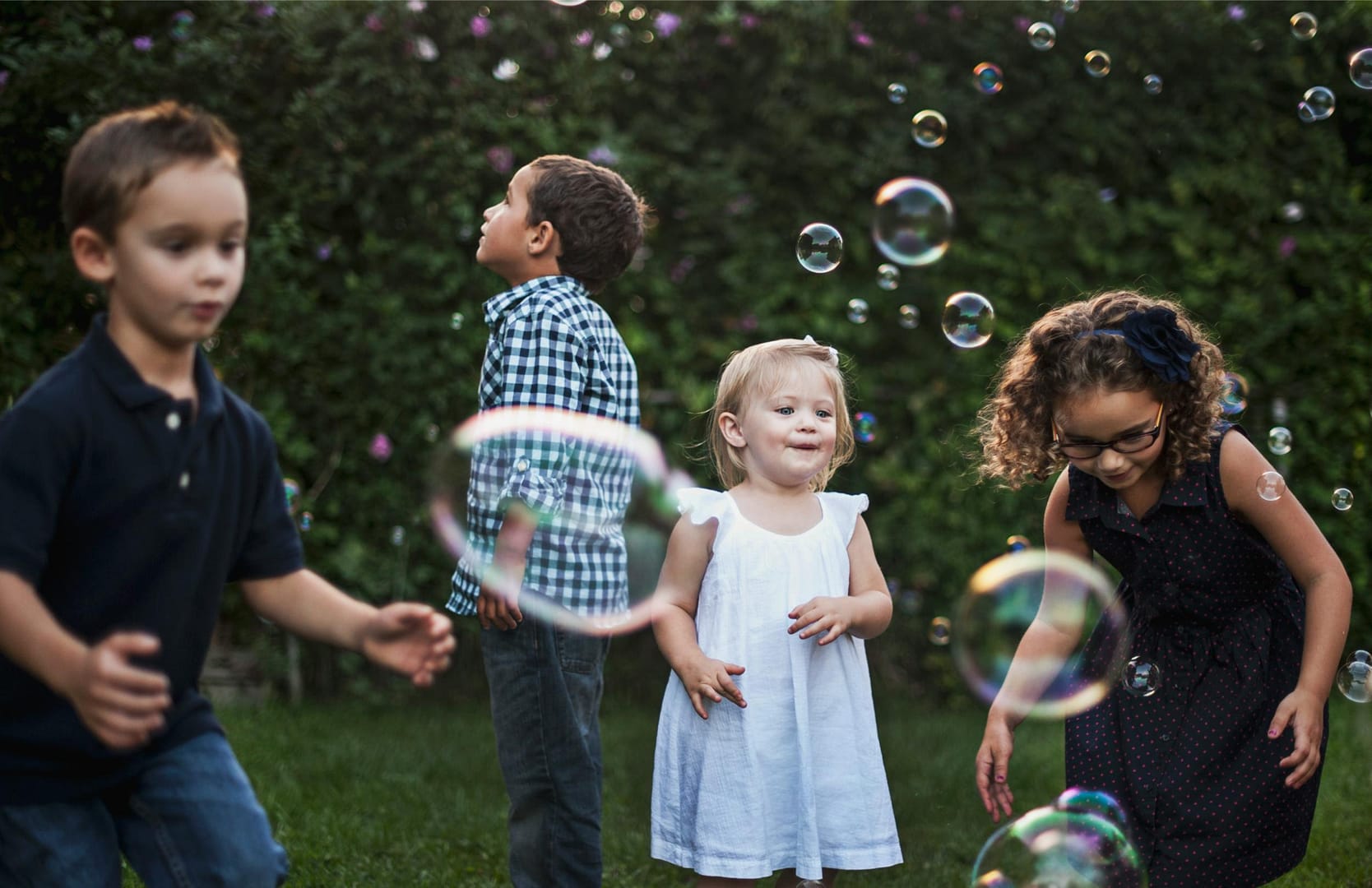 Kids playing with bubbles outside