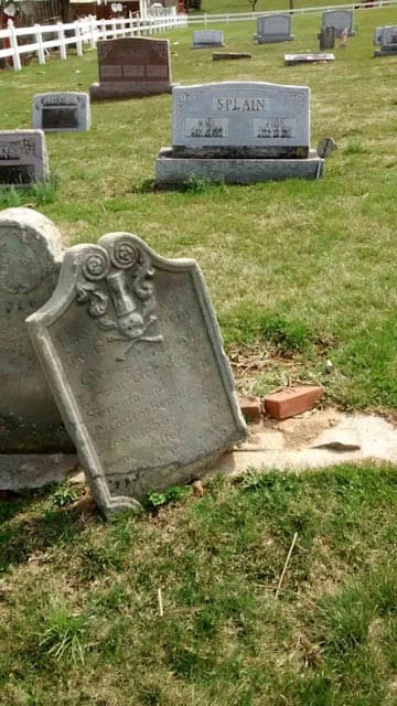 broken headstone before