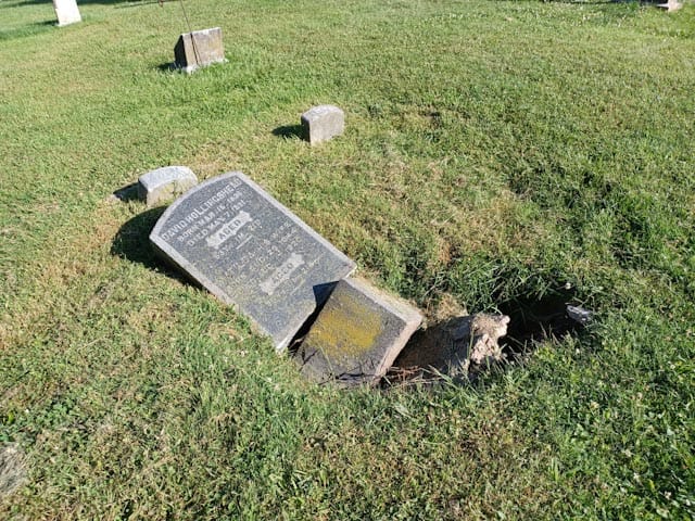 broken headstone before