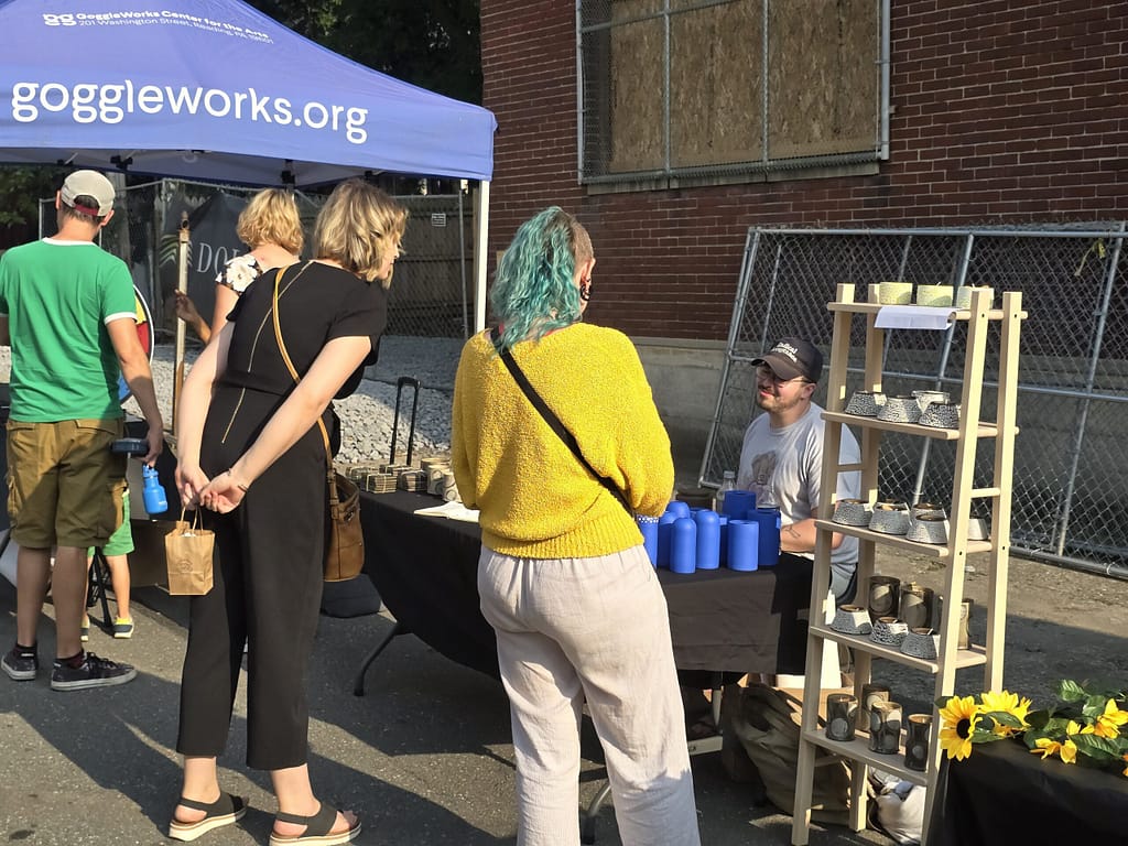 people shopping at the outdoor reading roots market stand