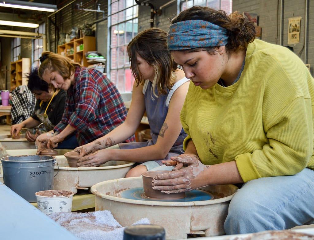 women working at the pottery wheel