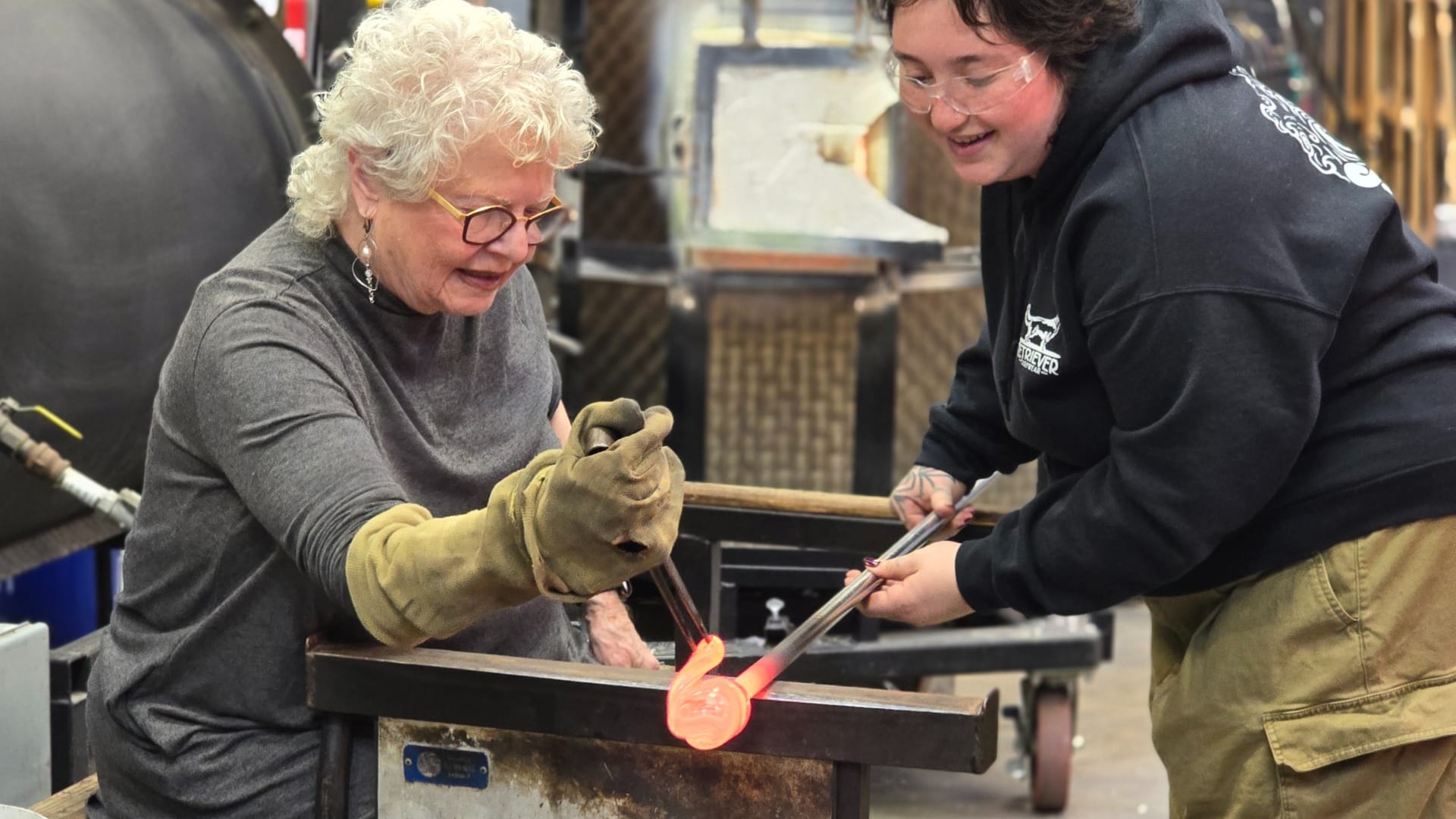 two women working in glassblowing class