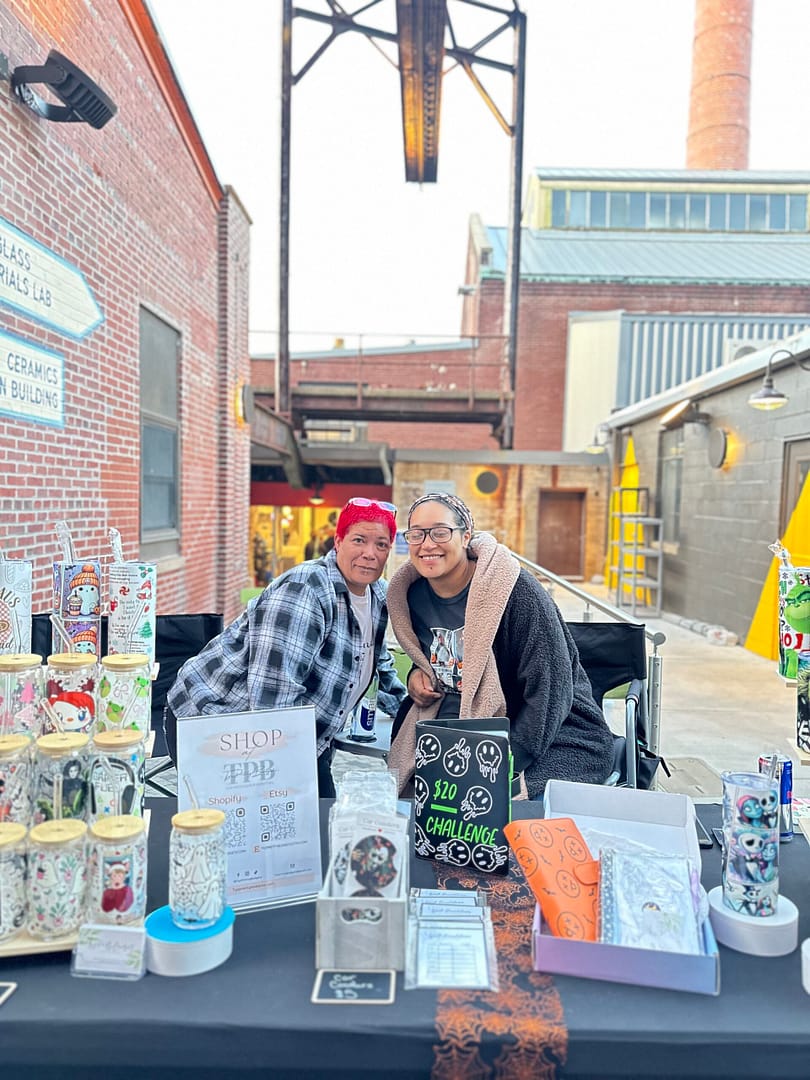 two woman selling handmade glassware