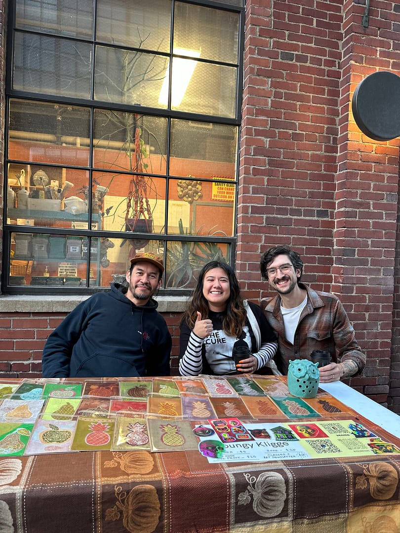 three artists selling textiles