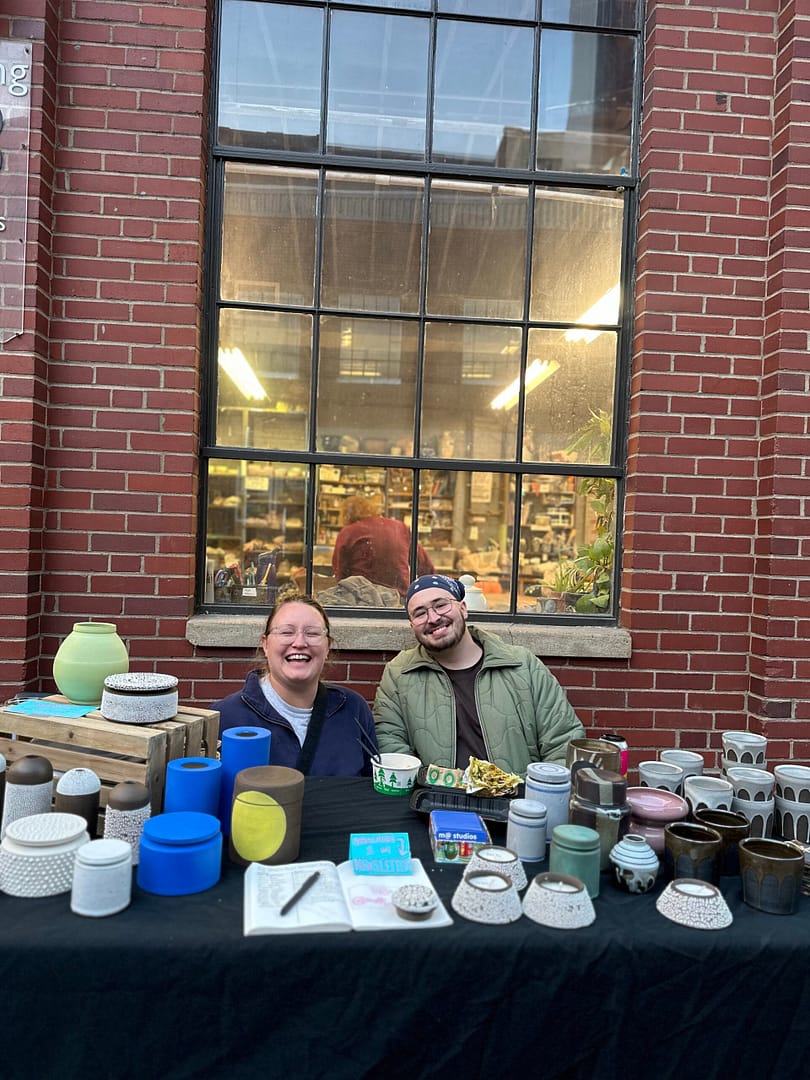 two artists selling pottery