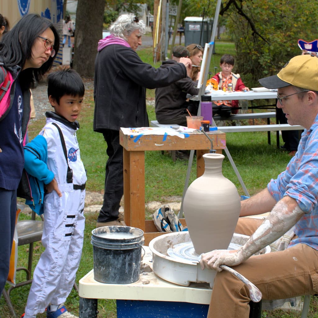 Ceramics and Painting teachers share their knowledge with youth visitors at the village open house community event. The artist call for this event is key to community engagement.