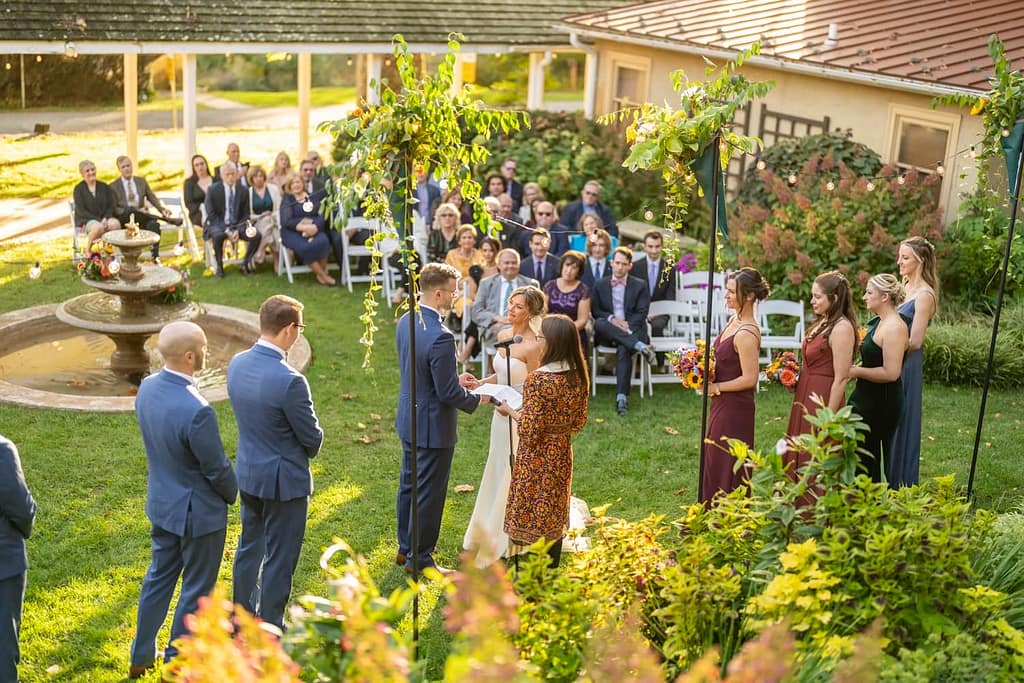 A marriage ceremony in the courtyard gardens at the wedding venue at Historic Yellow Springs.