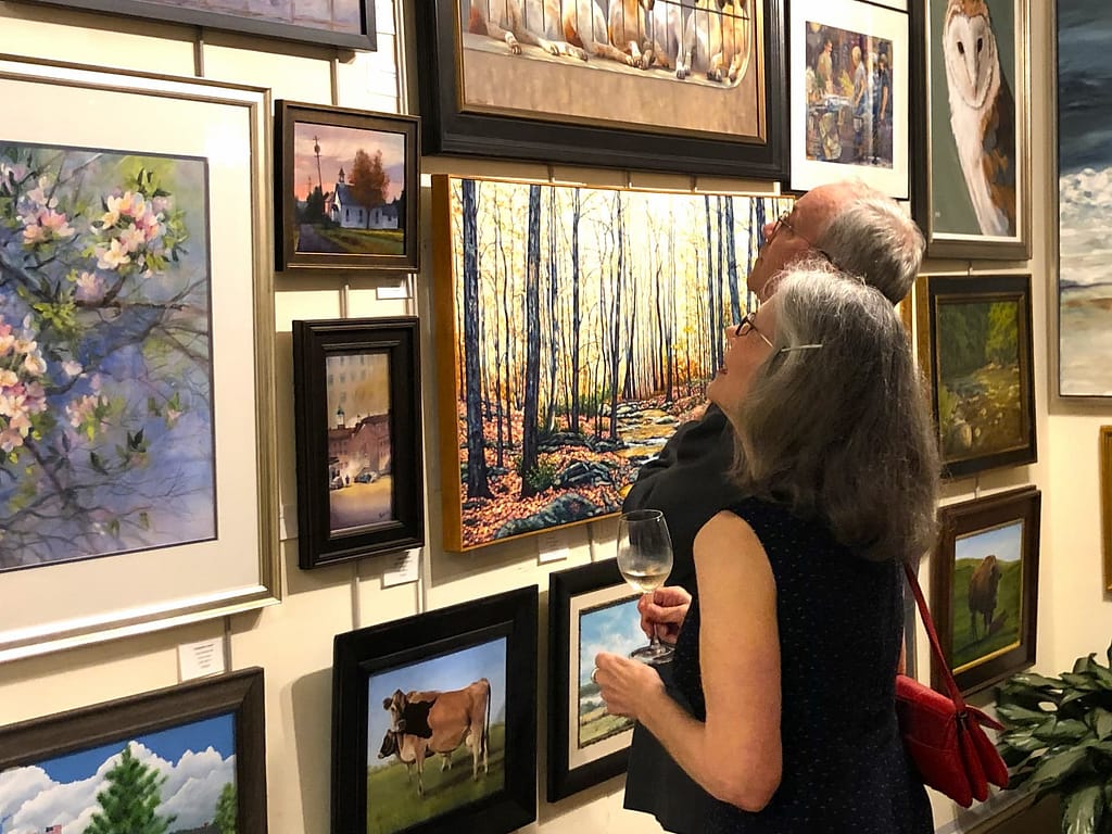 Community visitors admire the art in the galleries at the Yellow Springs art show and sale opening event.