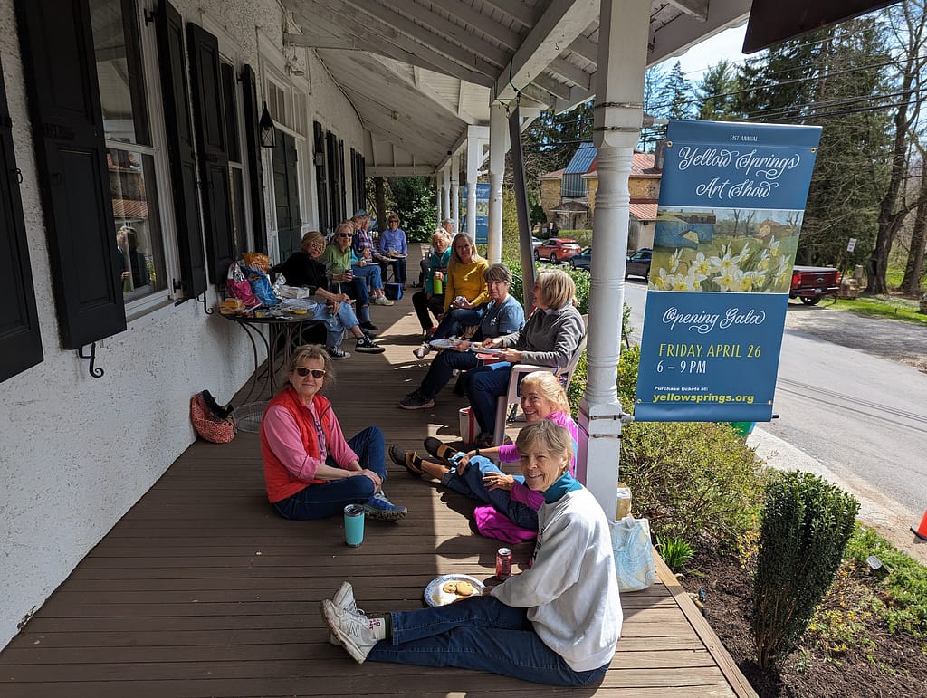 Garden clubs having lunch on the front porch of the historic Lincoln building after leading sustainable conservation efforts.