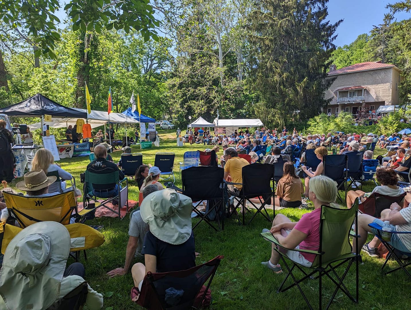 A large group of people gathered in a land preservation to celebrate the environment at historic yellow springs