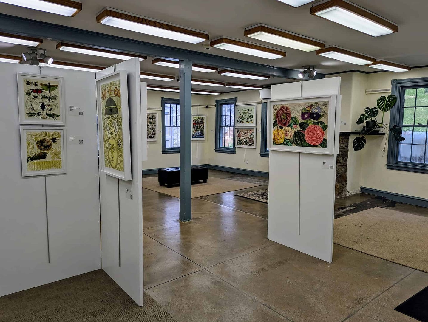 Artwork paintings are hung in the gallery for an exhibition by a local artist in the preserved building in the village on the national register of historic places.