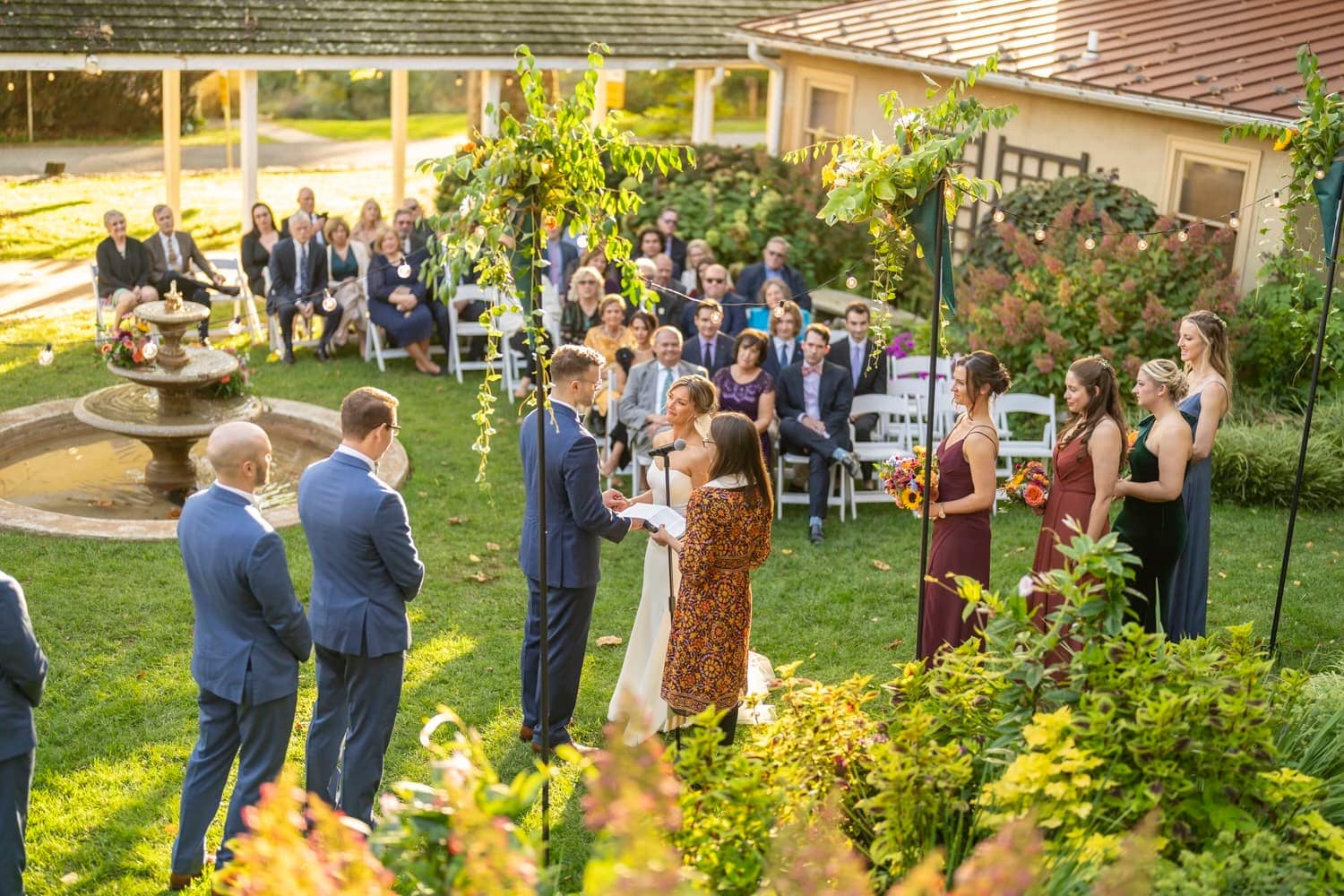 A marriage ceremony in the courtyard gardens at the wedding venue at Historic Yellow Springs.