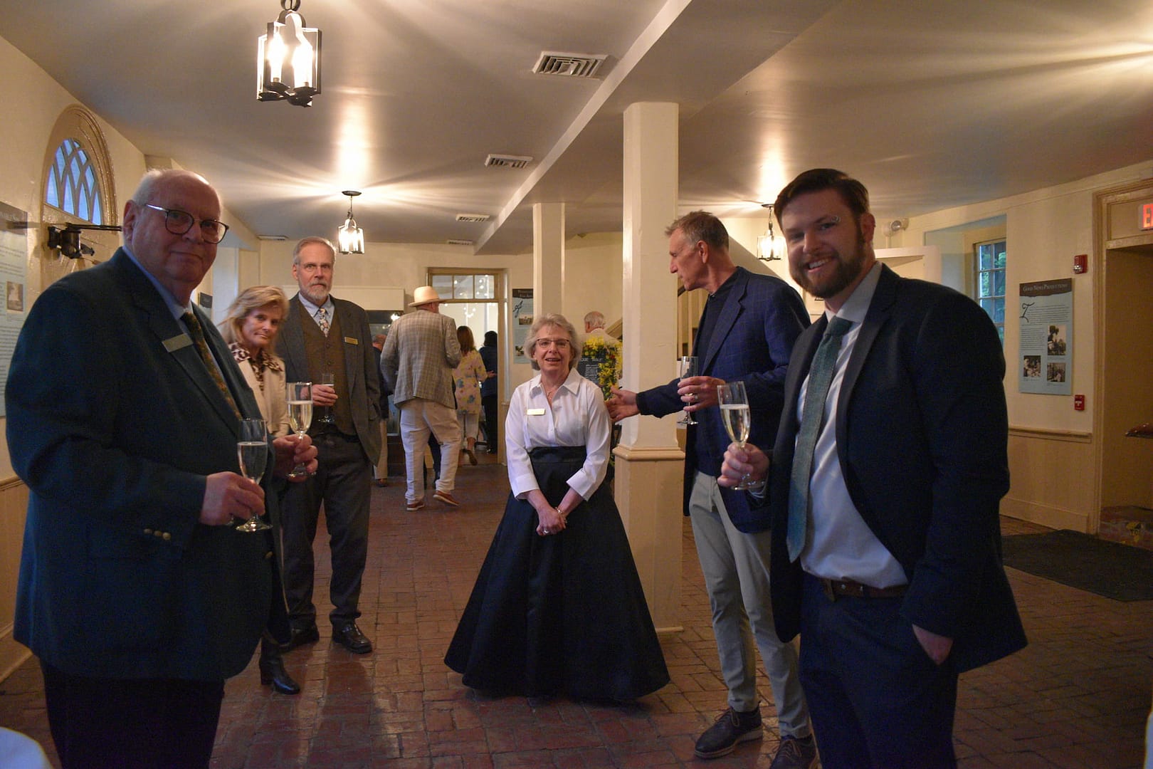 Hosts welcoming guests to the Washington Brick room part of the event space at the Washington Building Venue