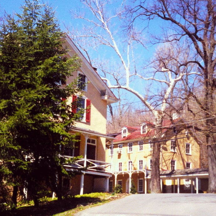 The portico walkway approaching the preserved historic Washington building, wedding venue, and courtyard gardens.