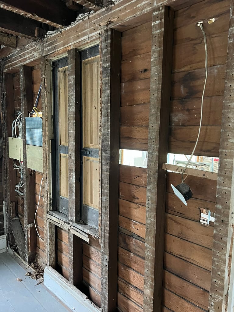 Old shutters with original paint discovered during exploratory demolition as part of the historic preservation project for the Connie's House restoration.