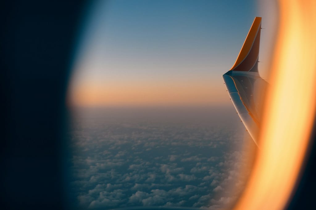 a view of the wing of an airplane in the sky